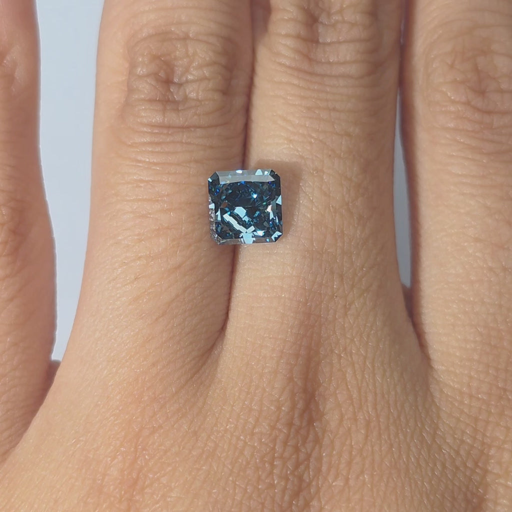 Lab diamond 2.01ct radiant brilliant cut fancy vivid blue VS2 by DovEggs hand modeled in warm indoor light.