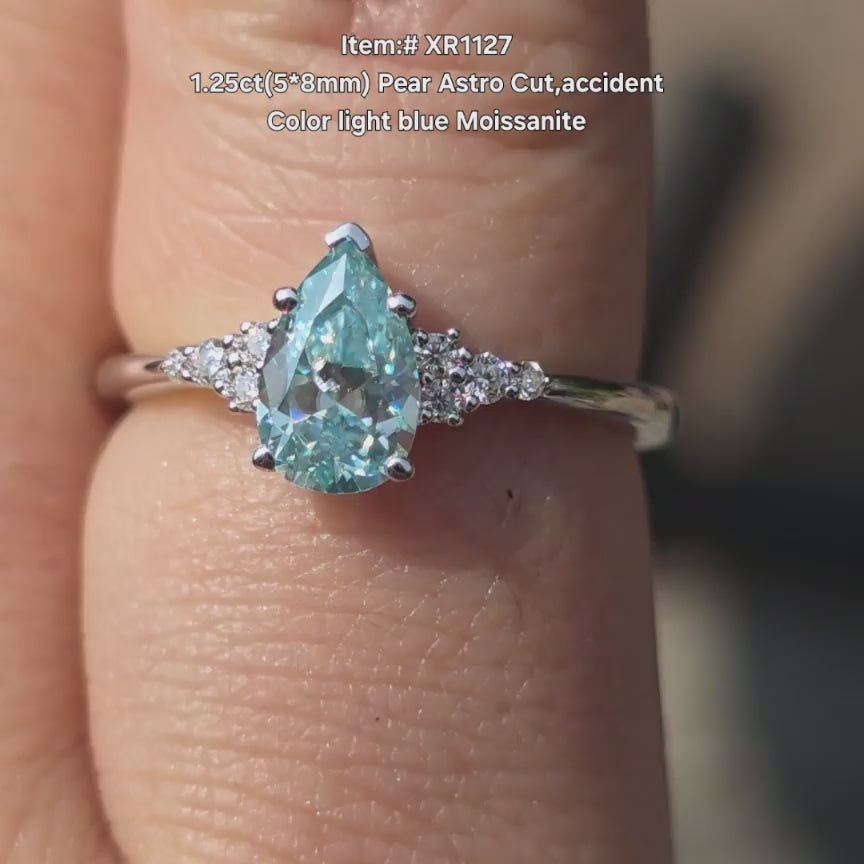 DovEggs Astro pear accident light blue moissanite ring sparkling in sunlight video
