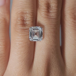Close-up video of 3.02ct Asscher diamond's concentric facets in warm light