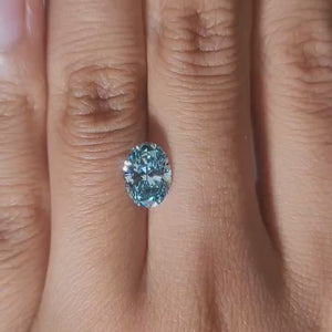 Finger-worn video of 1.665ct blue oval diamond in warmlight