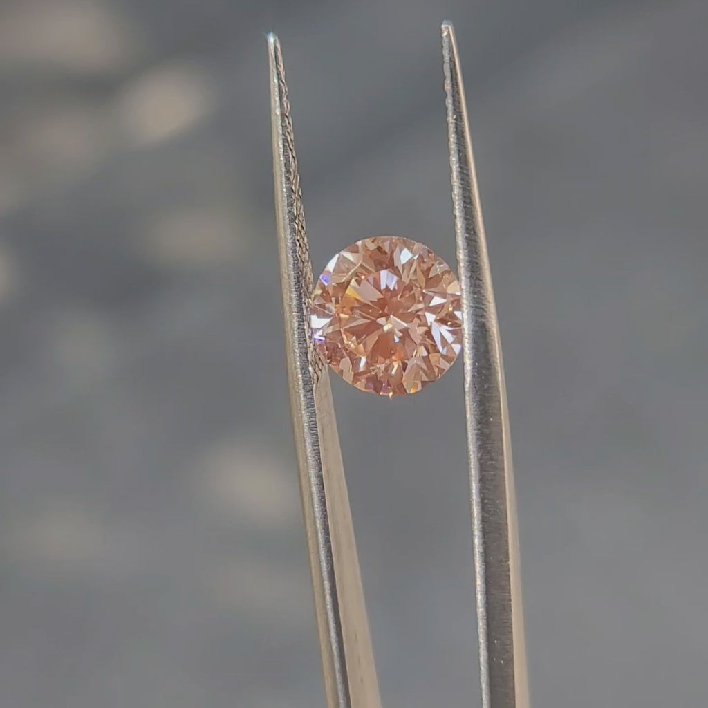3.01ct round brilliant fancy vivid pink diamond in sunlight, showing intense color