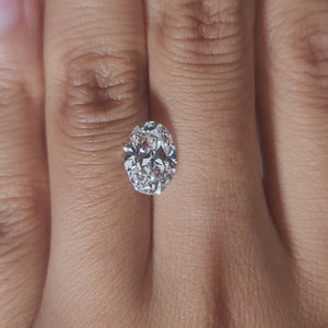 Hand-worn video of 2.021ct oval diamond in warm lighting