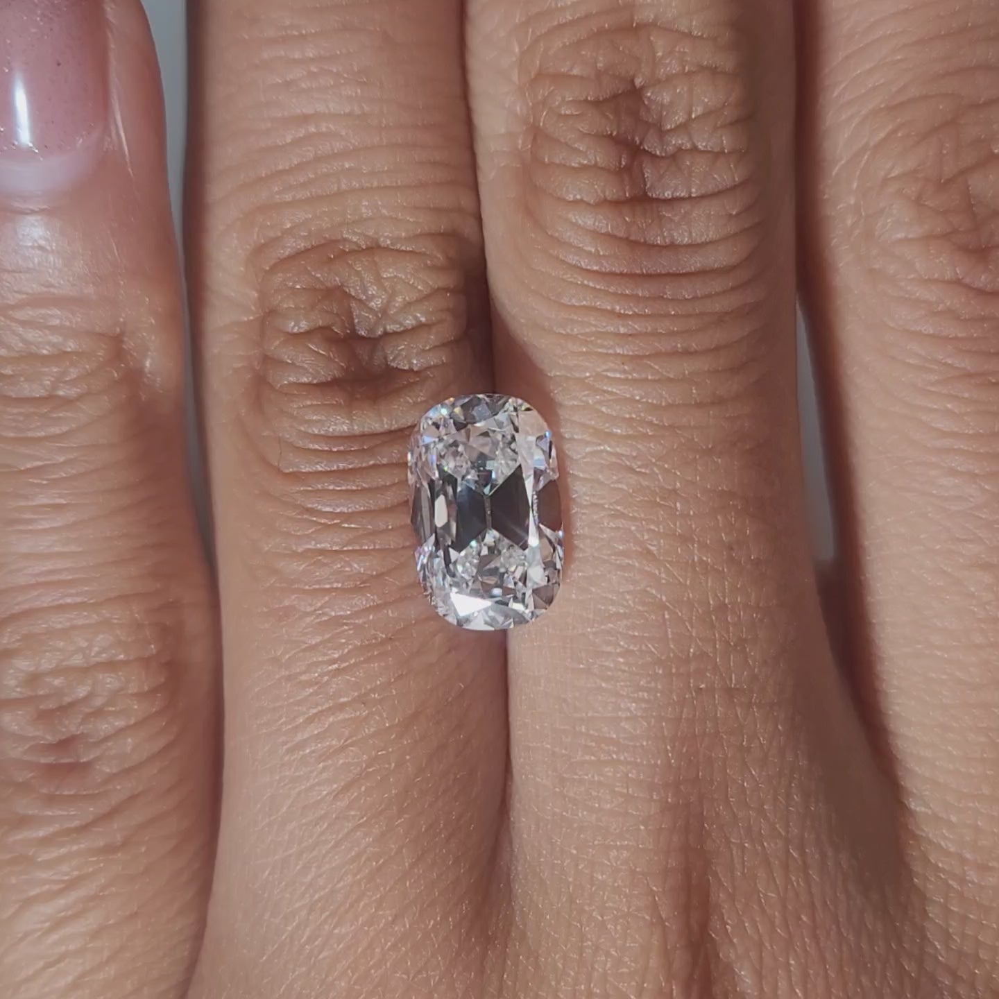 3.367ct Cushion E color VVS1 diamond glowing in warm handheld lighting