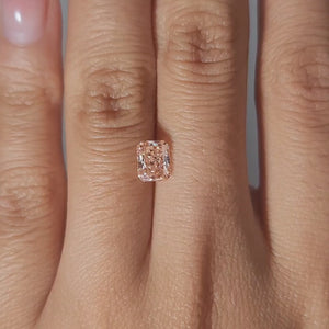 1.02ct-Radiant-Vivid-Pink diamond in warm lighting  on hand