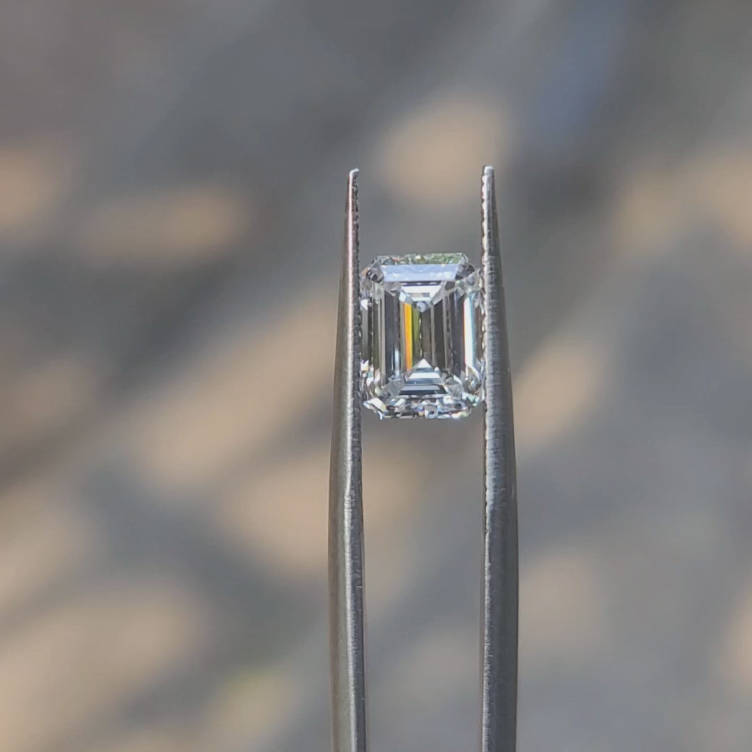 2.26ct emerald cut D color diamond video showing mirror-like facets in sunlight