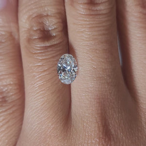 "Hand-modeled video of 1.27ct oval diamond in warm indoor lighting showcasing its sparkle"