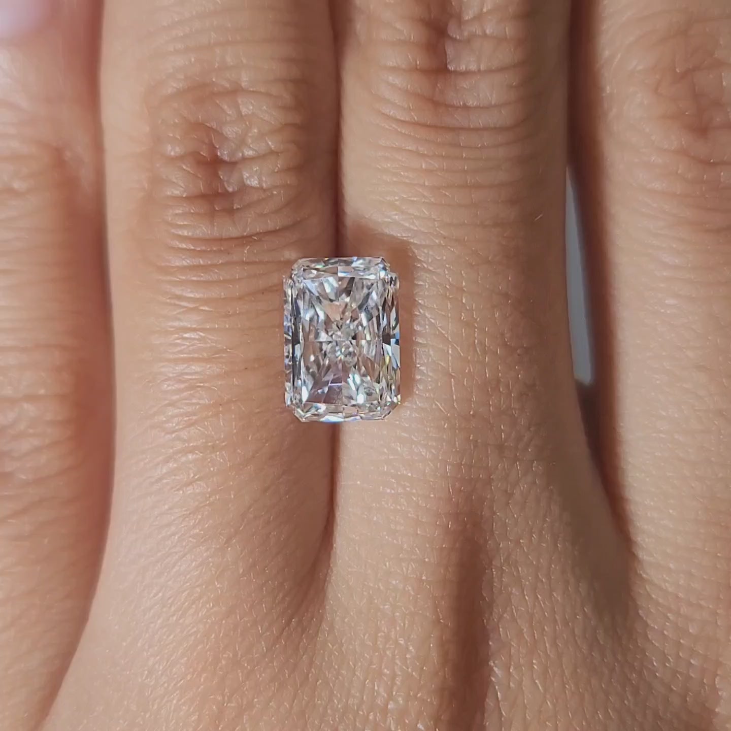 Modern video of 3.03ct radiant diamond in warm lighting