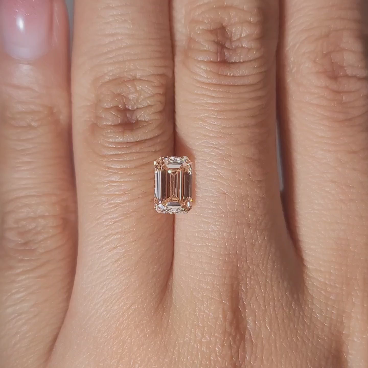 1.61ct Emerald fancy pink diamond in warm ambient lighting