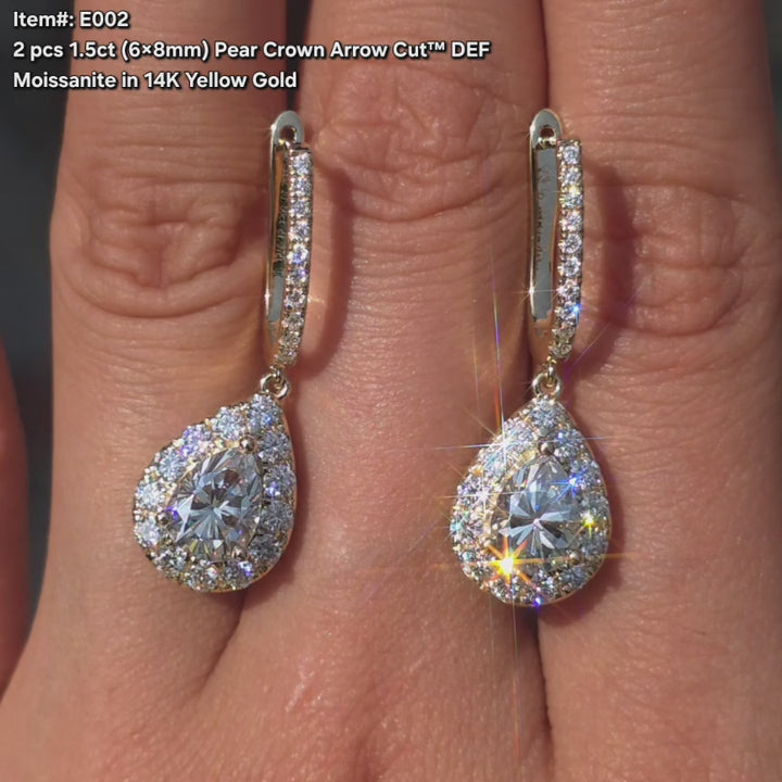 DovEggs Pear crown arrow cut moissanite earrings sparkling in sunlight video.