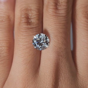 "Modeled video of 2.44ct round lab diamond in warm indoor lighting"