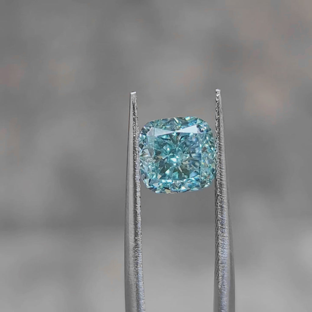 "Sunlight video showing 2.468ct cushion cut fancy bluish green diamond's ocean color"
