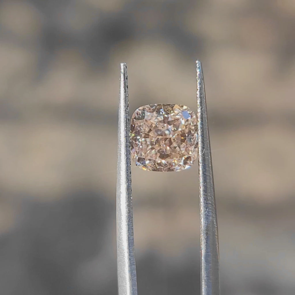 "Sunlight video showing 2.055ct cushion cut fancy pink diamond's soft hue"