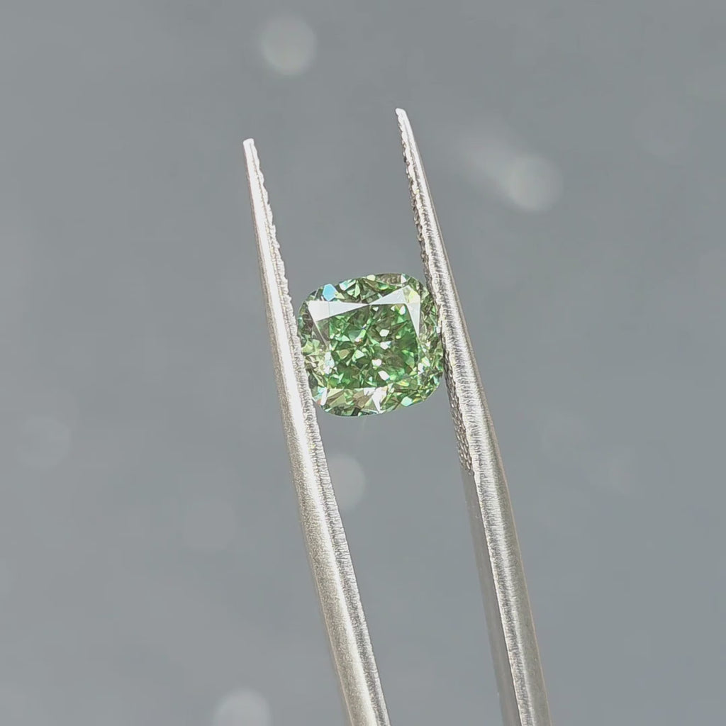 2.131ct cushion brilliant cut fancy vivid green VS1 lab diamond sparkling under outdoor sunlight.