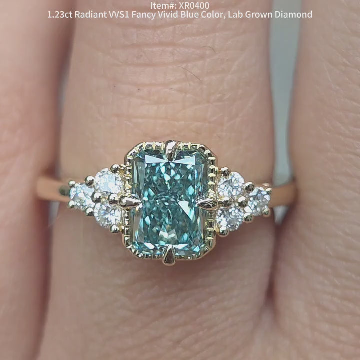 DovEggs 1.23ct radiant cut fancy blue lab grown diamond ring sparkling in sunlight video