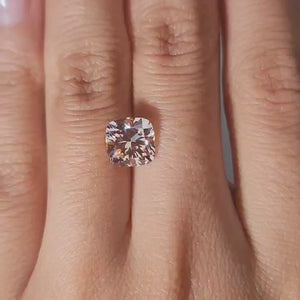 Indoor warm light: "2.72ct Cushion vivid pink diamond in warm handheld lighting