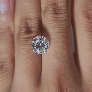 Close-up hand video of 3.013ct round diamond in soft indoor lighting