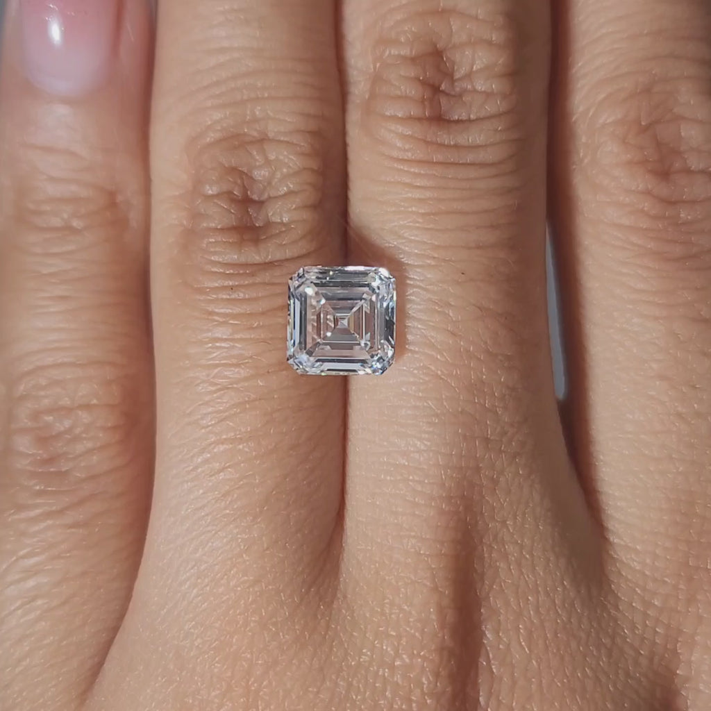 Finger-worn video of 2.54ct Asscher diamond in warm glow