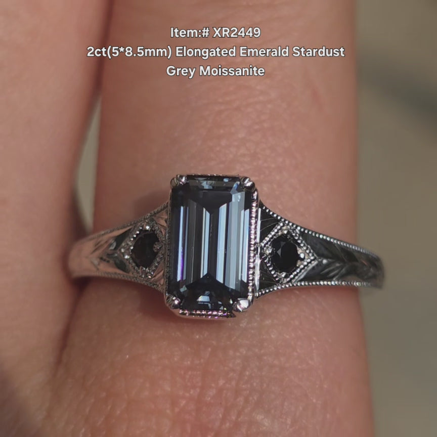 DovEggs elongated emerald stardust grey color moissanite ring sparkling in sunlight video.
