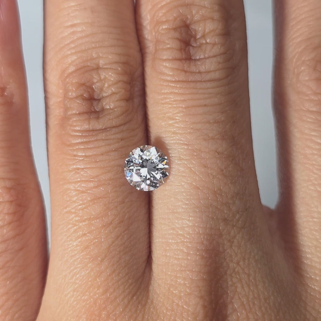 Hand modeling a 1.08ct Crown Arrow Cut™ lab diamond in warm indoor light.