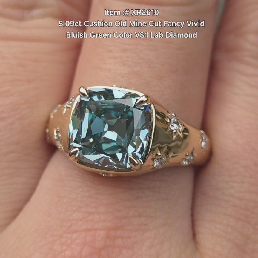 DovEggs cushion old mine cut fancy vivid bluish green color lab diamond ring sparkling in sunlight video.