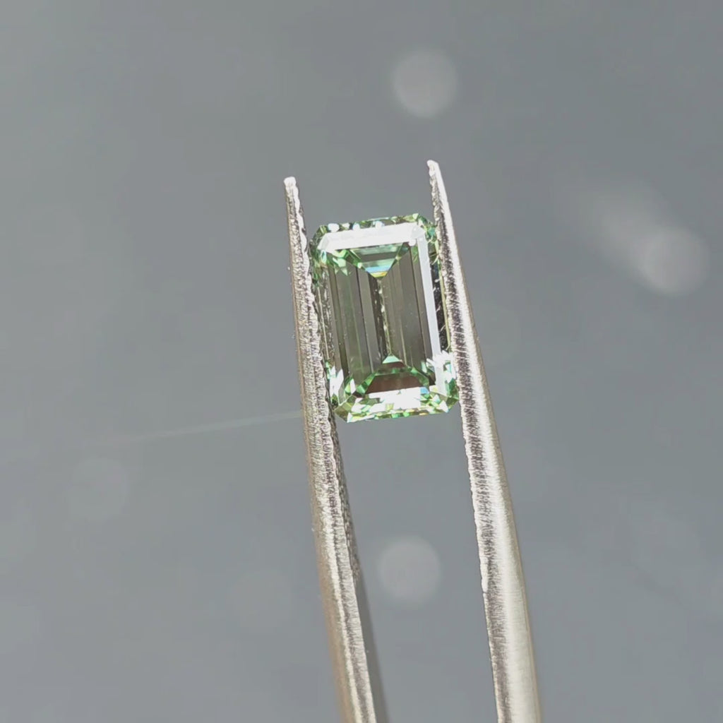 2.26ct emerald cut fancy vivid green VVS1 lab diamond showing intense color in outdoor sunlight.
