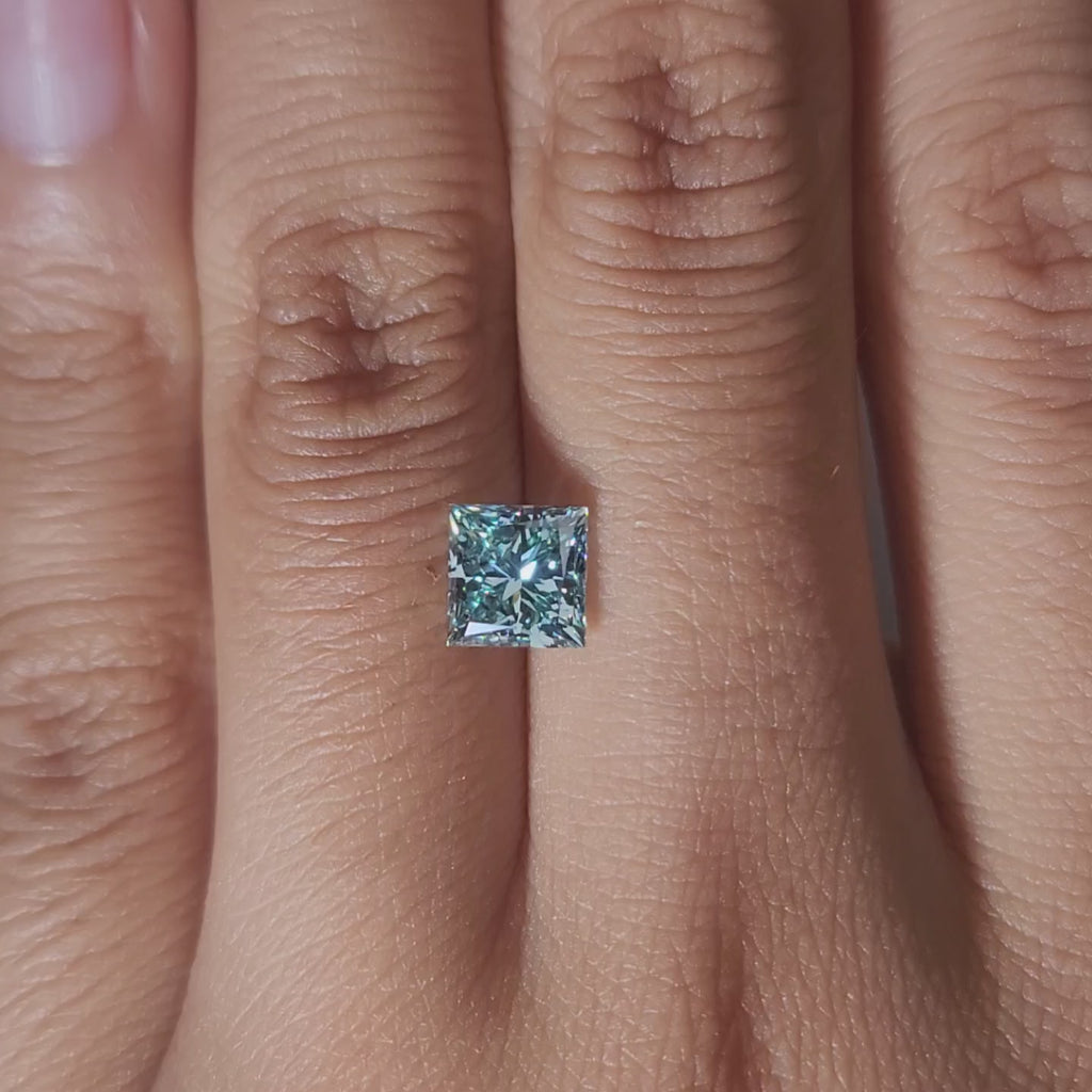 Hand-display video of 1.502ct blue princess diamond in warm glow