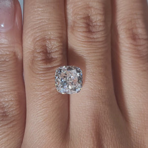 "Hand-modeled video of 3.863ct cushion diamond in warm indoor lighting"