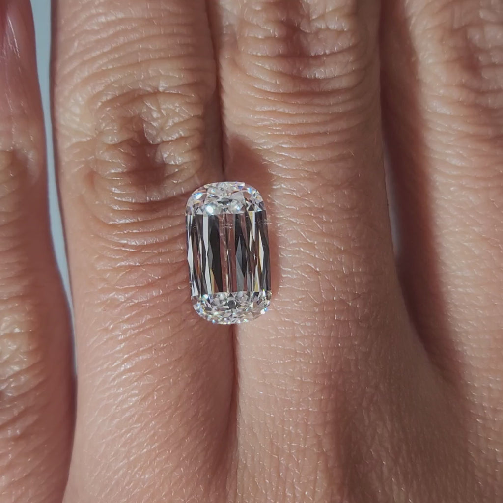 "Hand-modeled video of 3.637ct cushion diamond in warm indoor lighting"