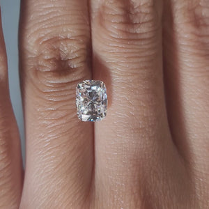 "Hand-modeled video of 2.105ct cushion diamond in warm indoor lighting"