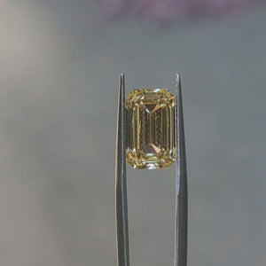 6.482ct emerald cut fancy yellow diamond's step cuts in sunlight