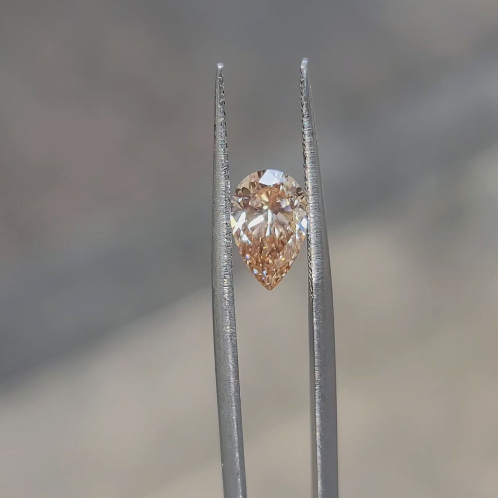 1.50ct Pear lab diamond radiating fiery orange tones in sunlight