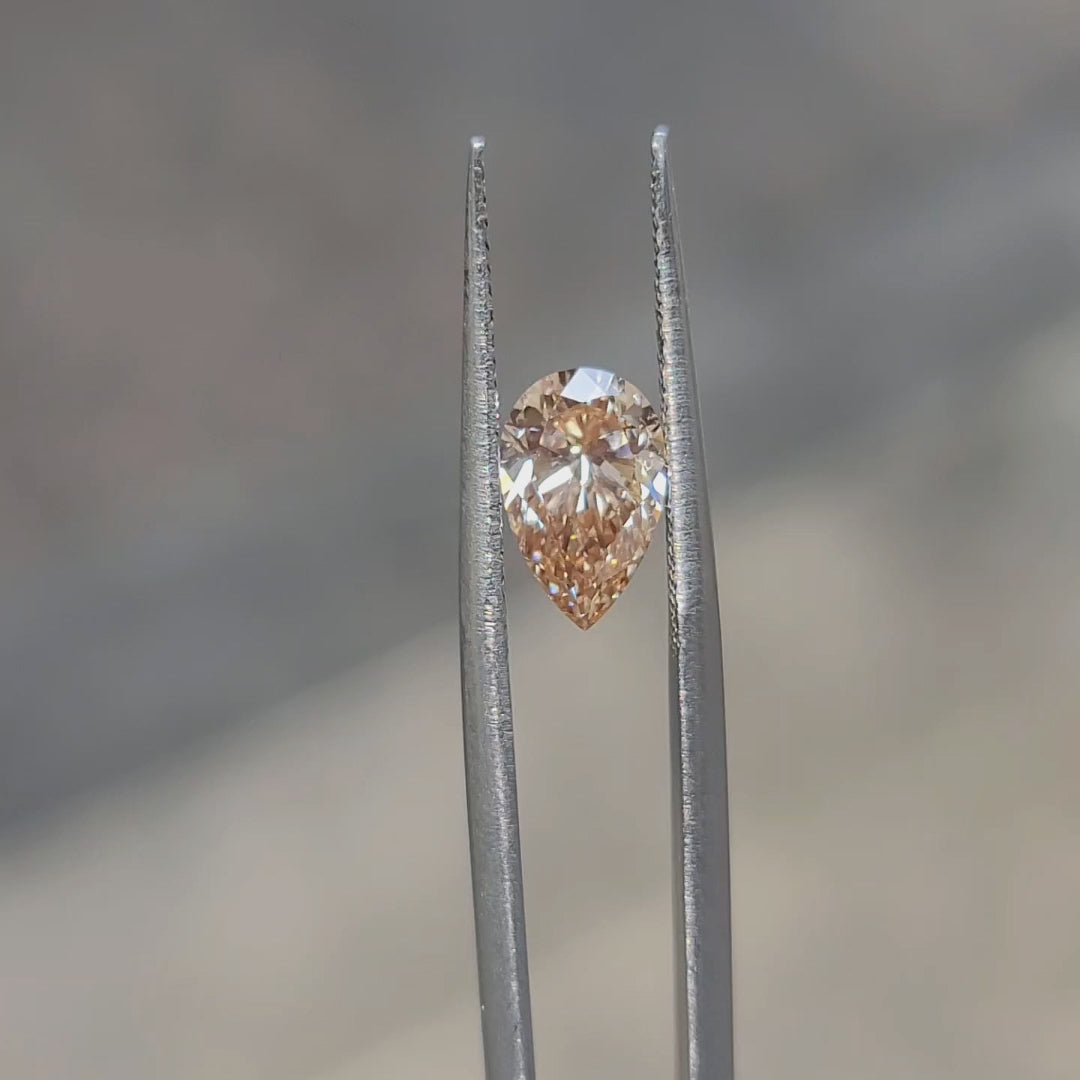 1.50ct Pear lab diamond radiating fiery orange tones in sunlight