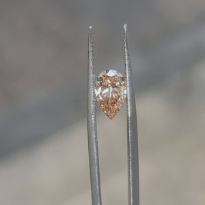 1.50ct Pear lab diamond radiating fiery orange tones in sunlight