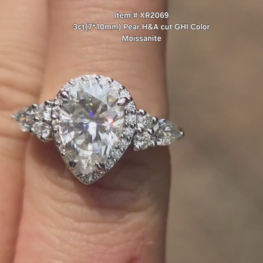 DovEggs pear halo side stones moissanite engagement ring in sunlight