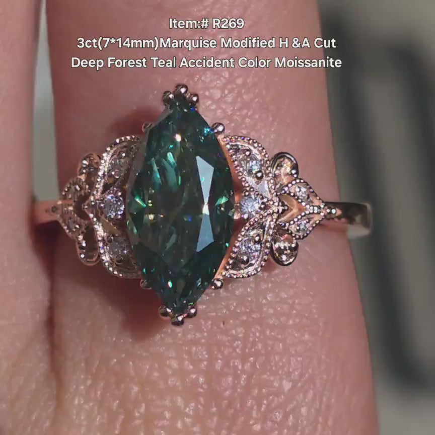DovEggs forest teal marquise with side stones moissanite engagement ring in sunlight