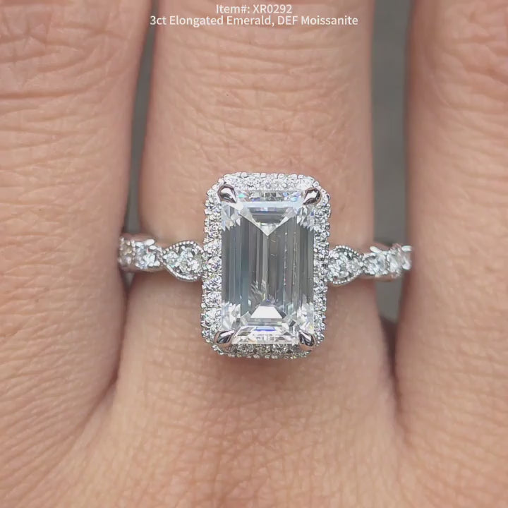 DovEggs DEF color elongated emerald moissanite ring sparkling in sunlight video
