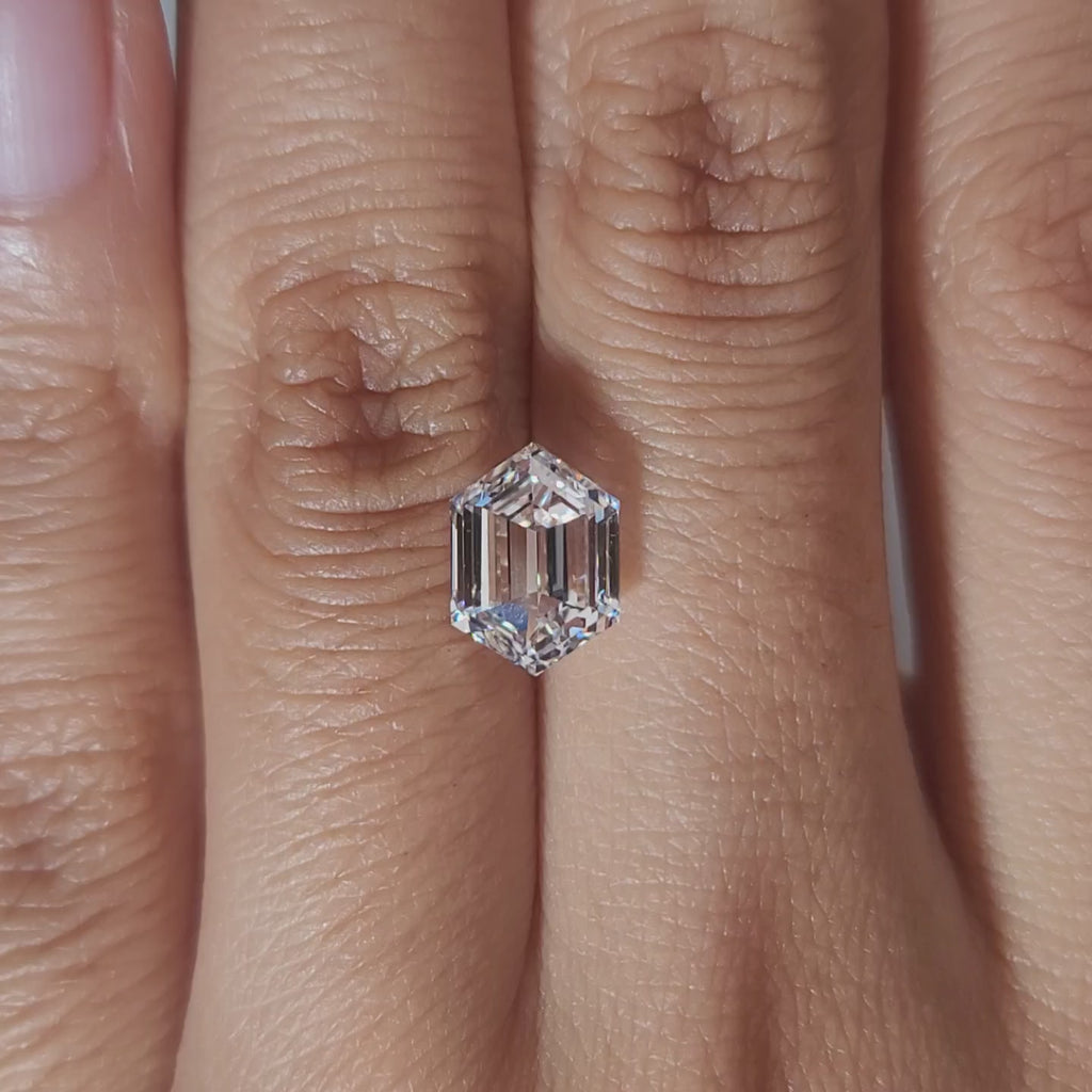 "Hand-modeled video of 2.3ct marquise diamond in warm indoor lighting"