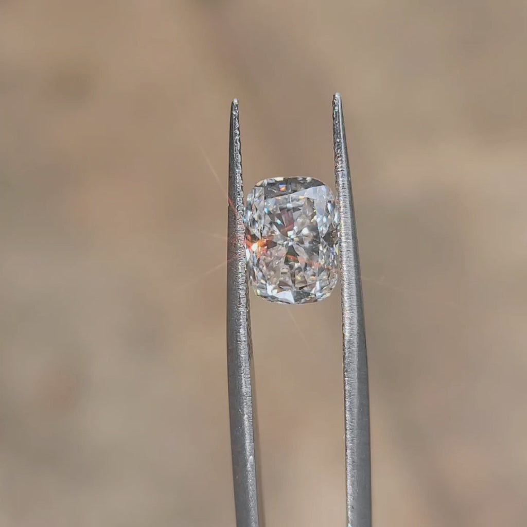 Natural light video of 3.04ct cushion cut's size and E color