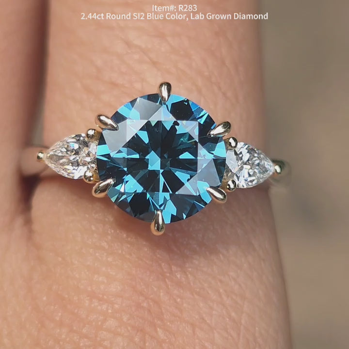 DovEggs 2.44ct Round cut SI2 clarity blue color lab grown diamond ring sparkling in sunlight video.