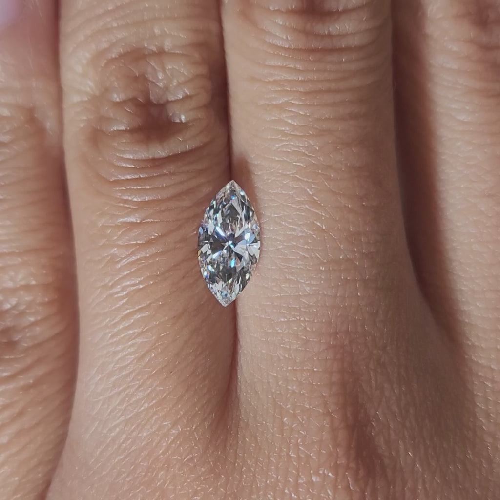 "Hand-modeled video of 1.12ct marquise diamond in warm indoor lighting"
