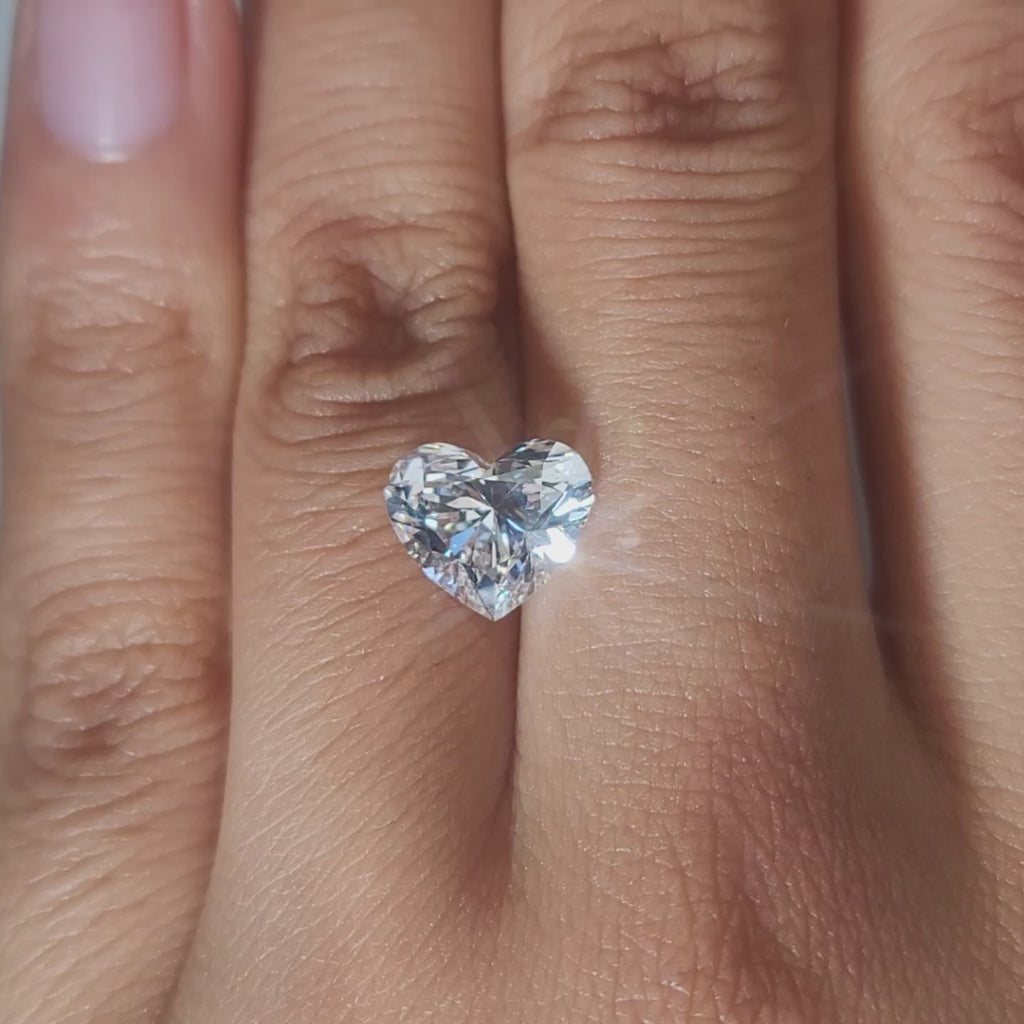 Close-up hand video of 2.54ct heart diamond in warmlight