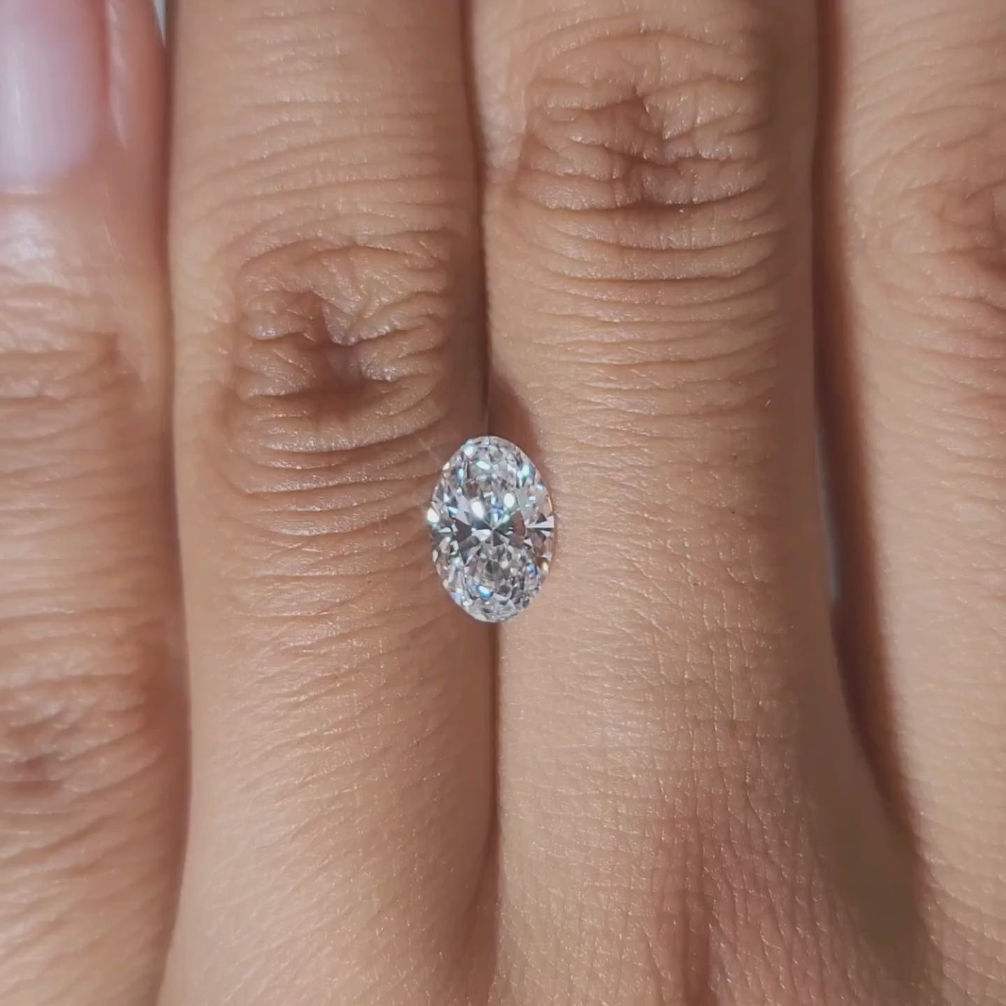 Hand-worn video of 1.01ct oval lab diamond under cozy indoor lighting