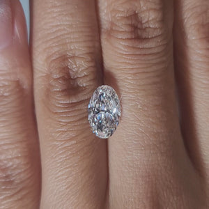 "Hand-modeled video of 1.914ct oval diamond in warm indoor lighting"