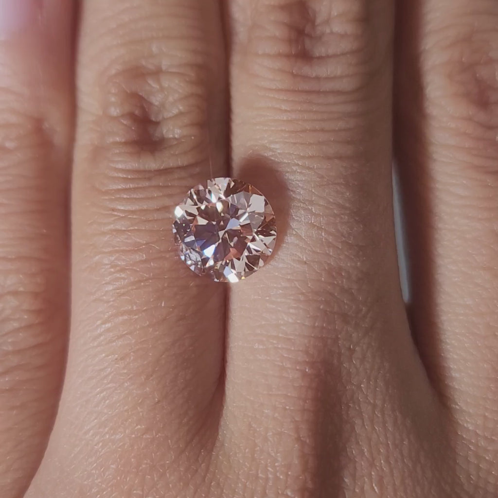 Close-up video of 3.01ct pink diamond rotating in soft lighting