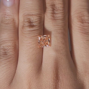 Close-up slow motion of 2.067ct princess cut diamond's brilliant facets under warm lighting
