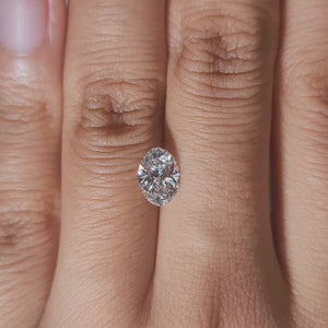 Close-up hand video of 1.02ct oval diamond in soft indoor lighting