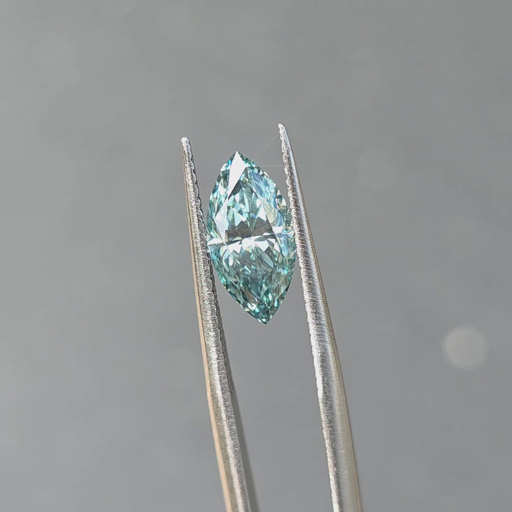 Outdoor sunlight reveals the unique sparkle of a 2.08ct marquise brilliant cut fancy vivid blue lab diamond.