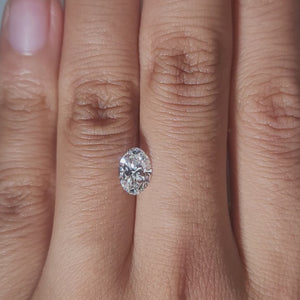 Close-up hand video of 1.01ct oval diamond in warm candlelight