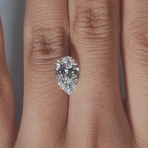 Hand-display video showing 2.50ct pear diamond in warm home lighting