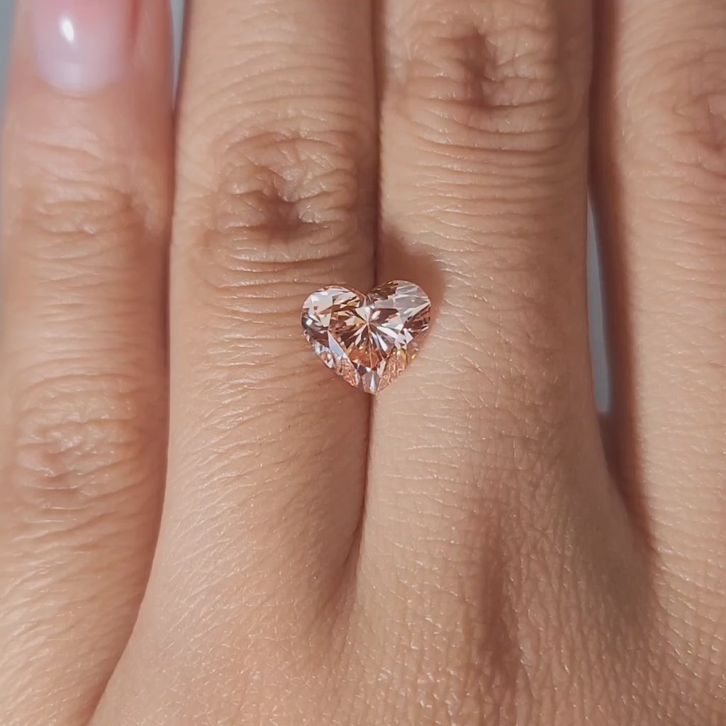 2.10ct Heart vivid pink diamond in warm handheld lighting